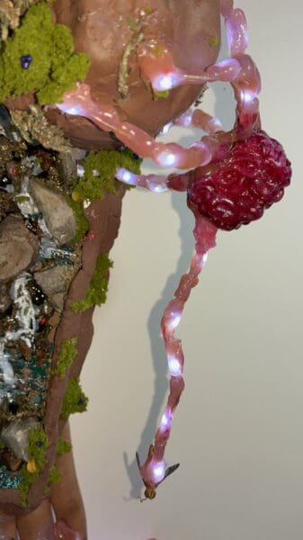 Glowing pink fairy lights on a mossy miniature tree