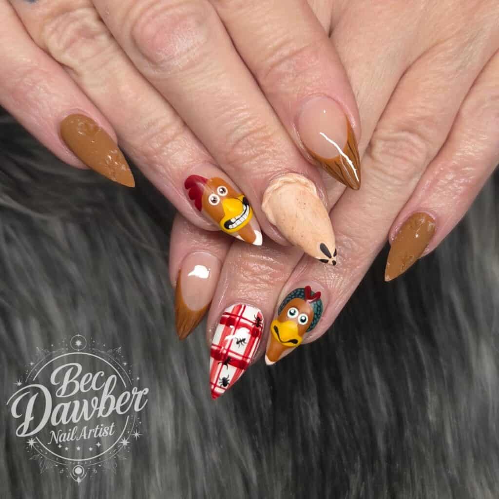 Autumnal chicken-themed nail art on long pointed nails