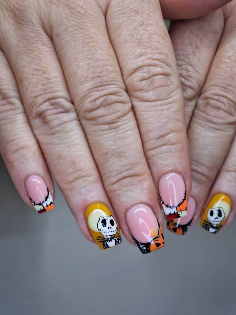 Hands with colourful Nightmare Before Christmas themed nail art