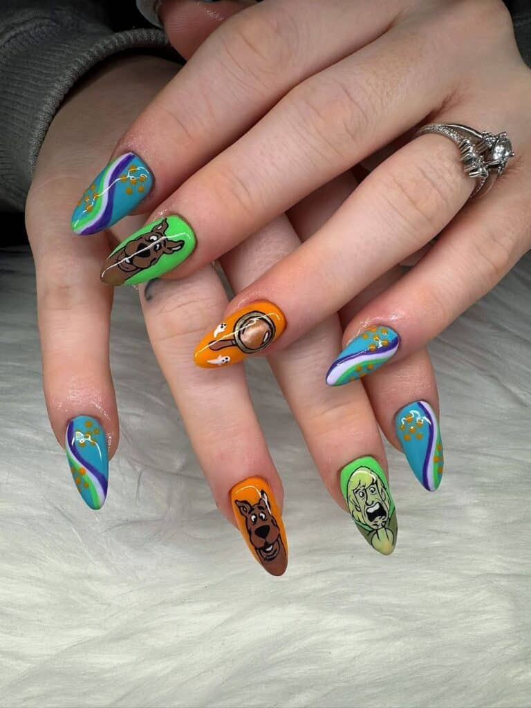 Colourful Scooby-Doo themed nail art on long pointed nails