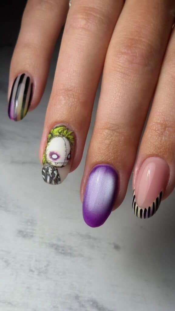 Halloween nail art with stitched doll and purple ombré