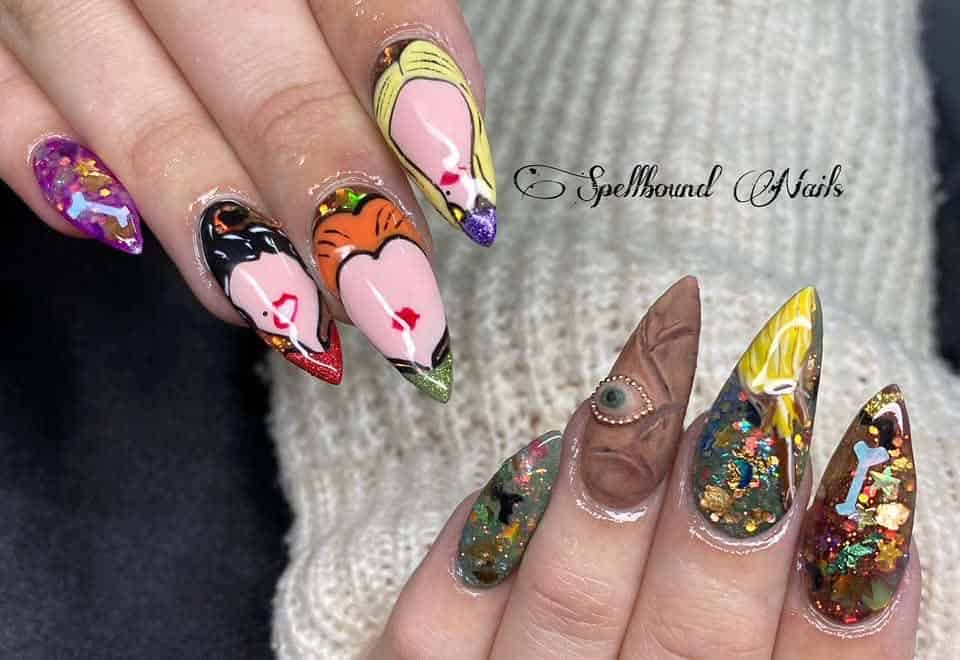 Hands with colourful, pointed Halloween-style nail art
