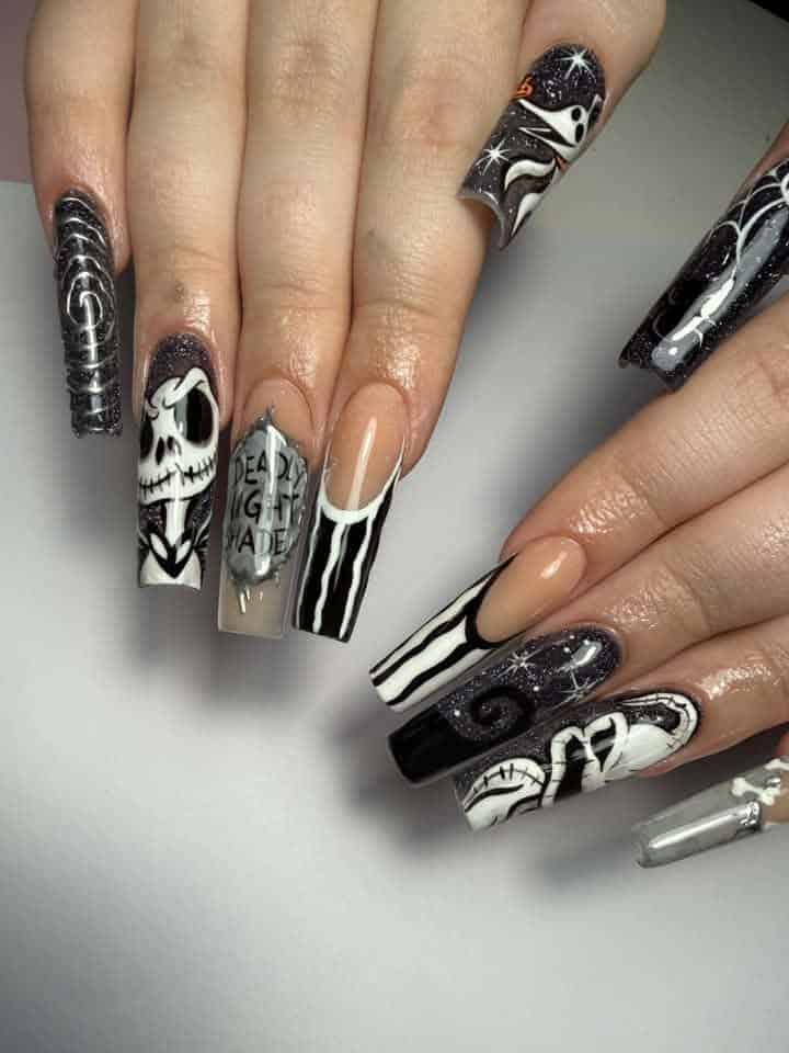 Black-and-white gothic manicure with skeleton and skull nail art