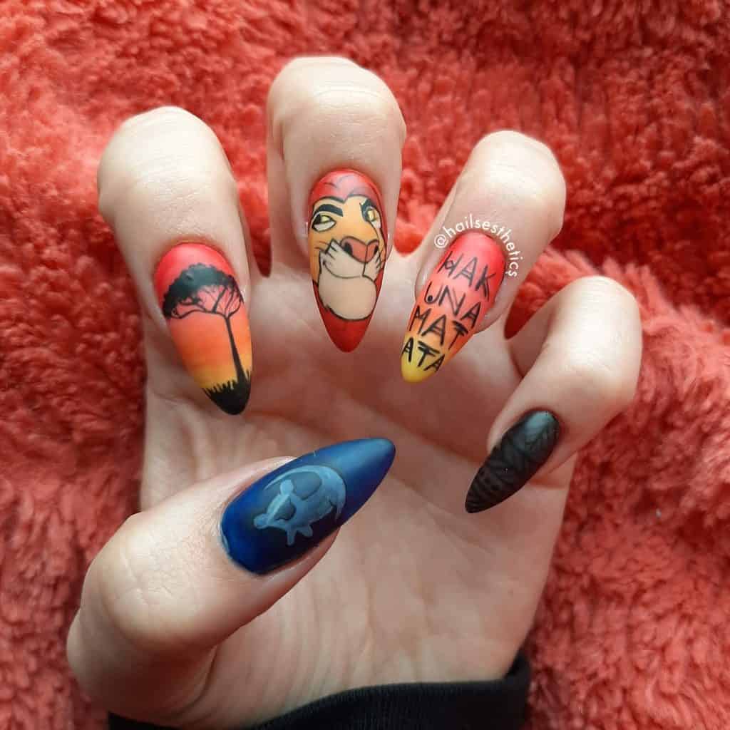 Lion King themed nail art on long pointed nails