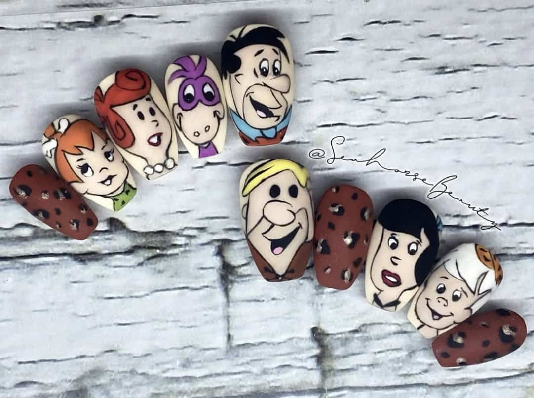Flintstones character nail art on a marble background