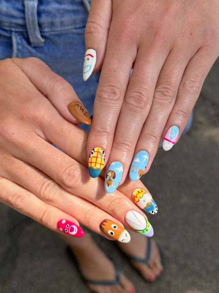 Hands displaying colourful Toy Story themed nail art