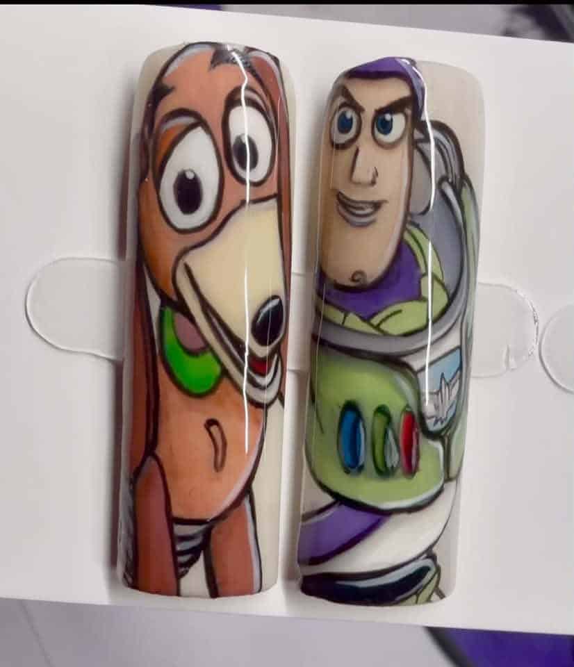 Toy Story character nail art featuring Slinky Dog and Buzz