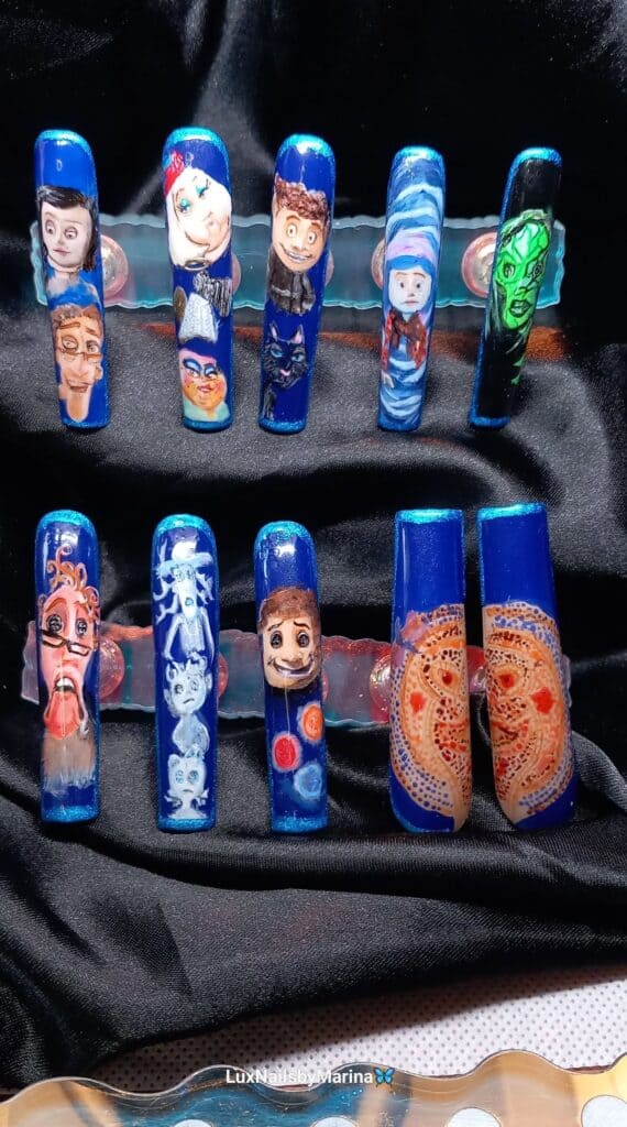Blue artificial nails with intricate hand-painted character designs