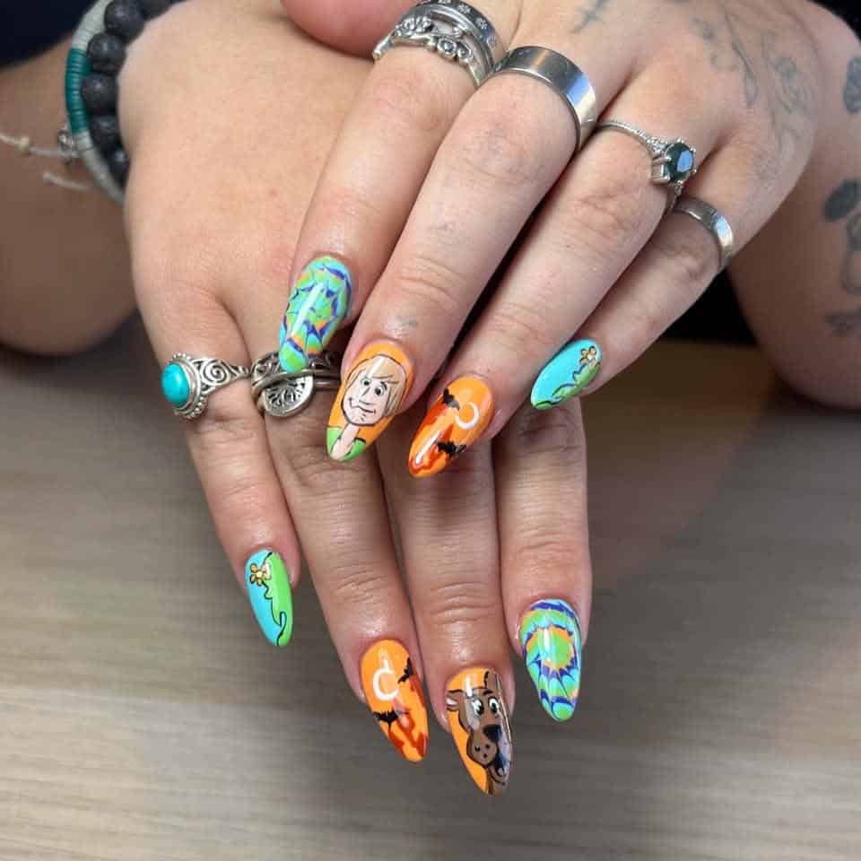 Colourful Scooby-Doo themed nail art on ringed hands