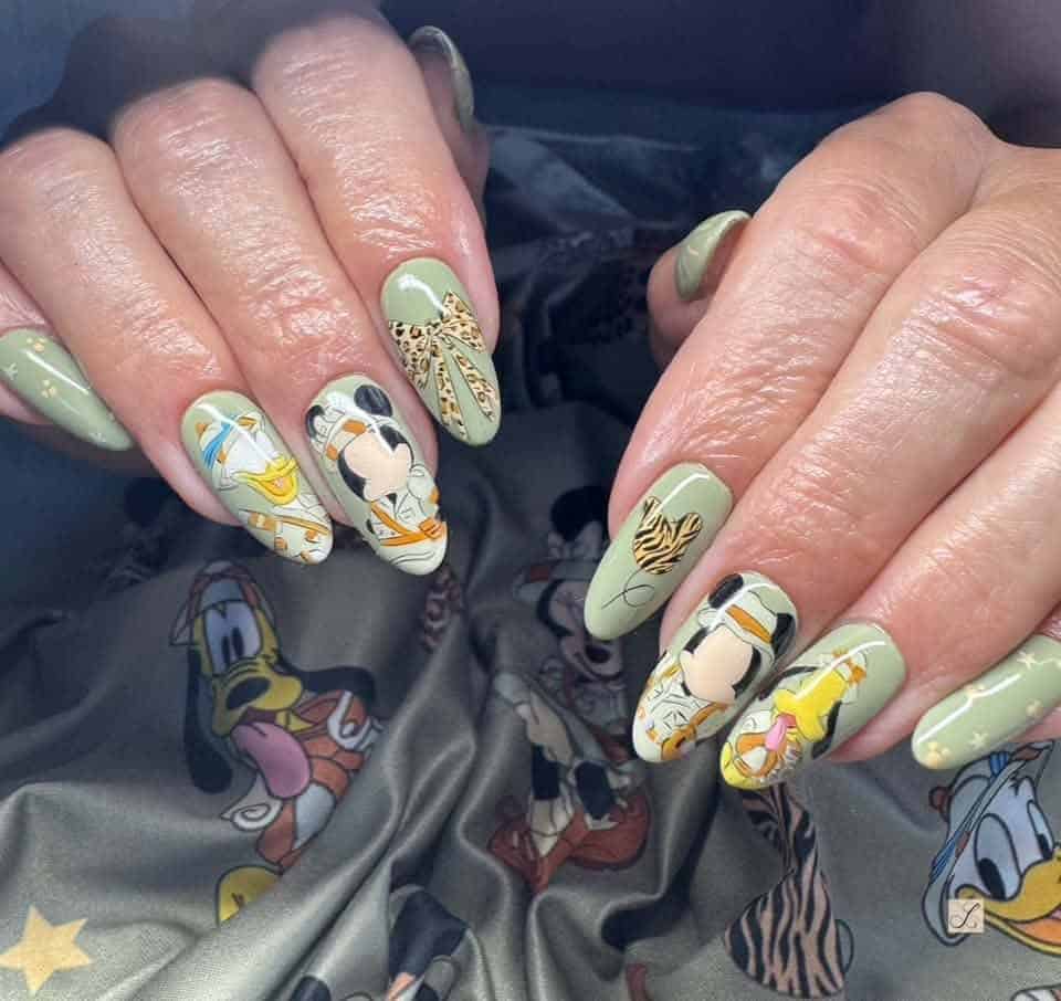 Green Disney character nail art on hands