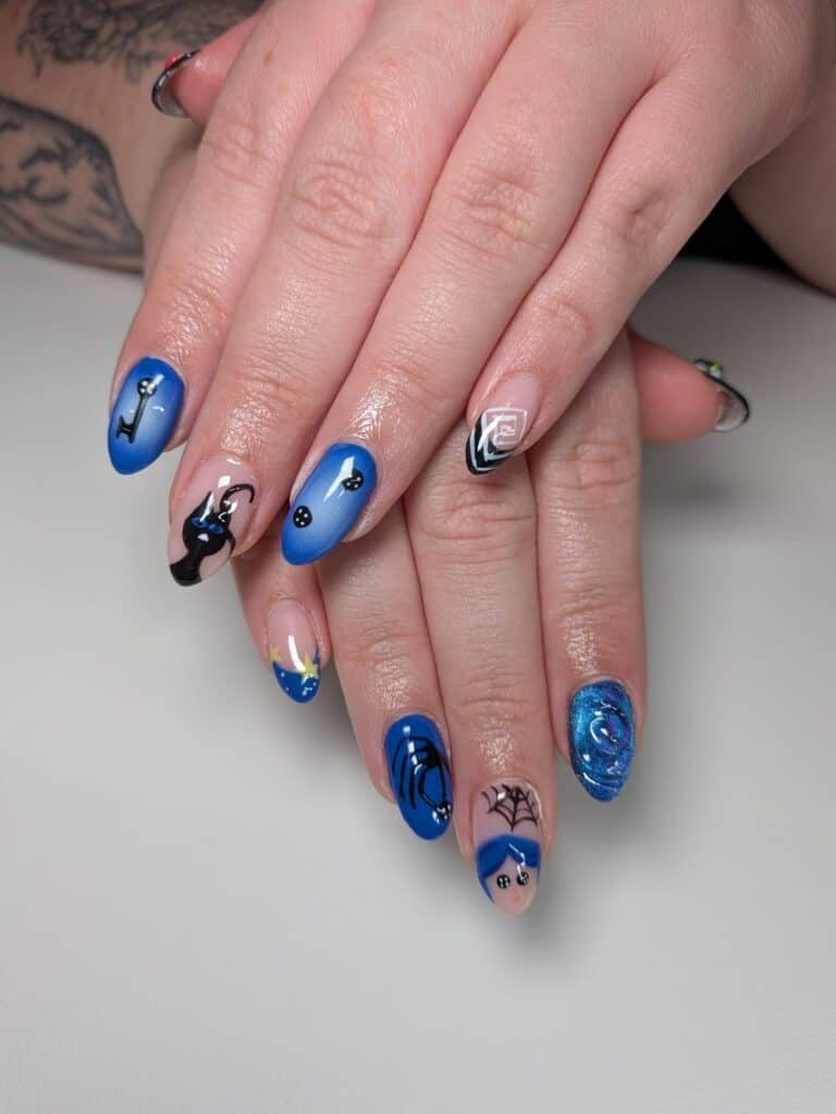 Blue and black gothic nail art on manicured hands
