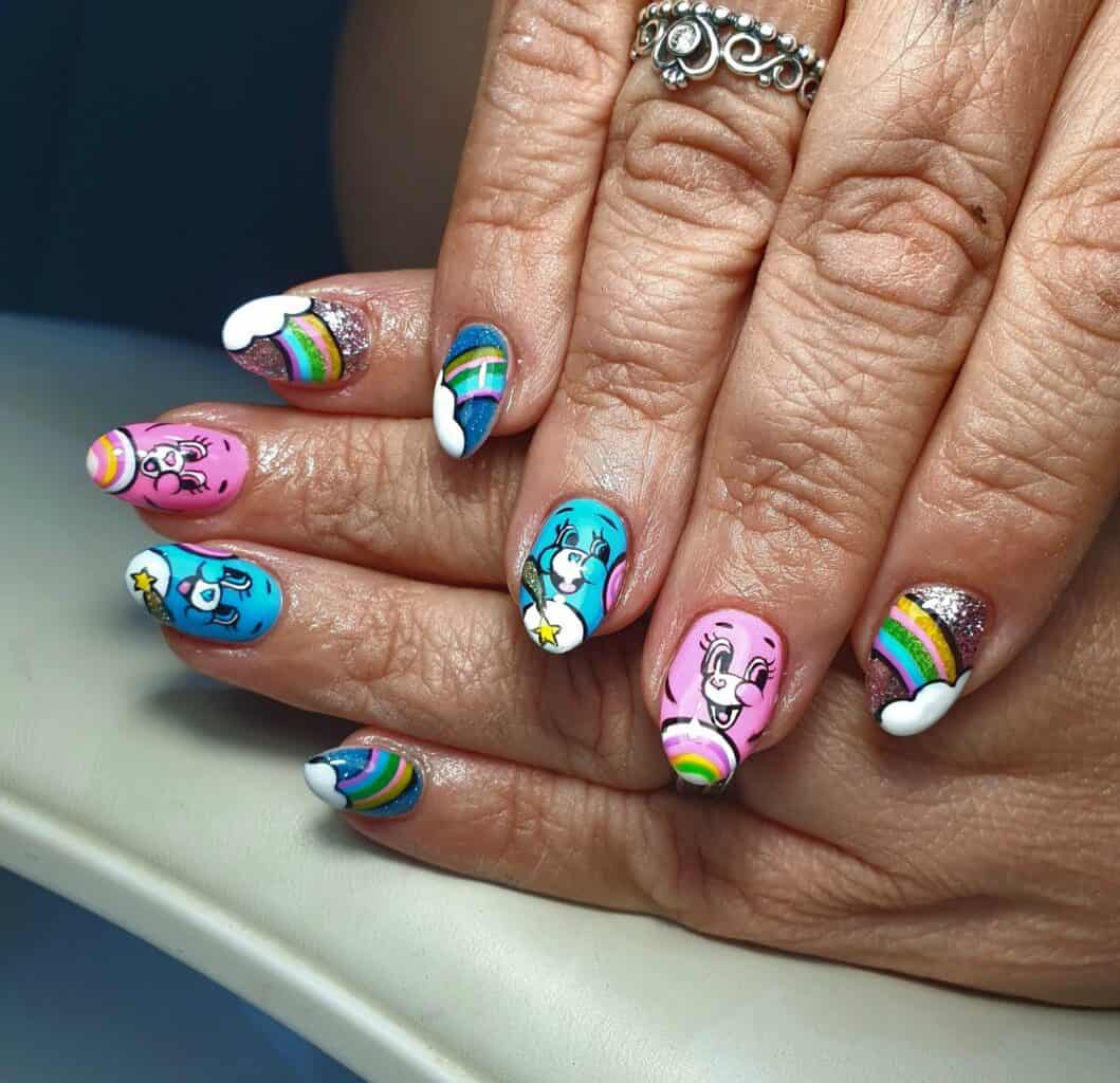 Hands with colourful rainbow and cartoon character nail art