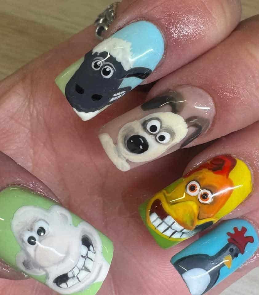 Colourful cartoon character nail art on manicured fingernails