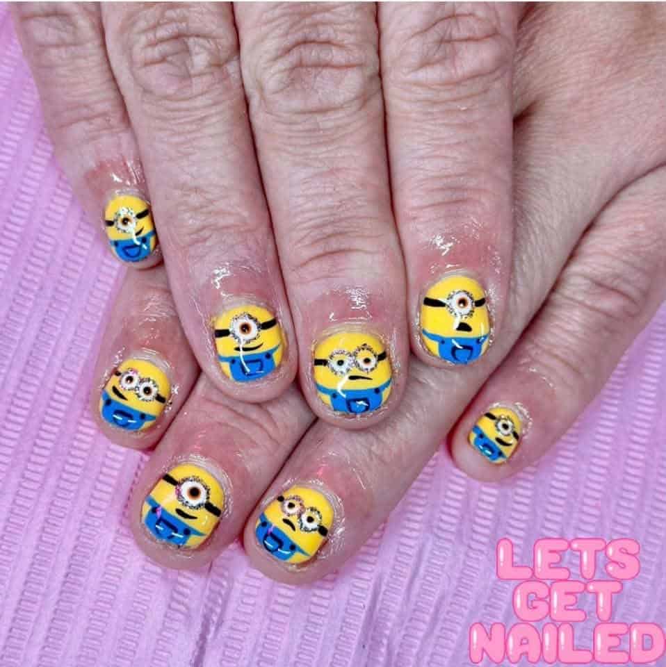Hands with yellow Minion character nail art