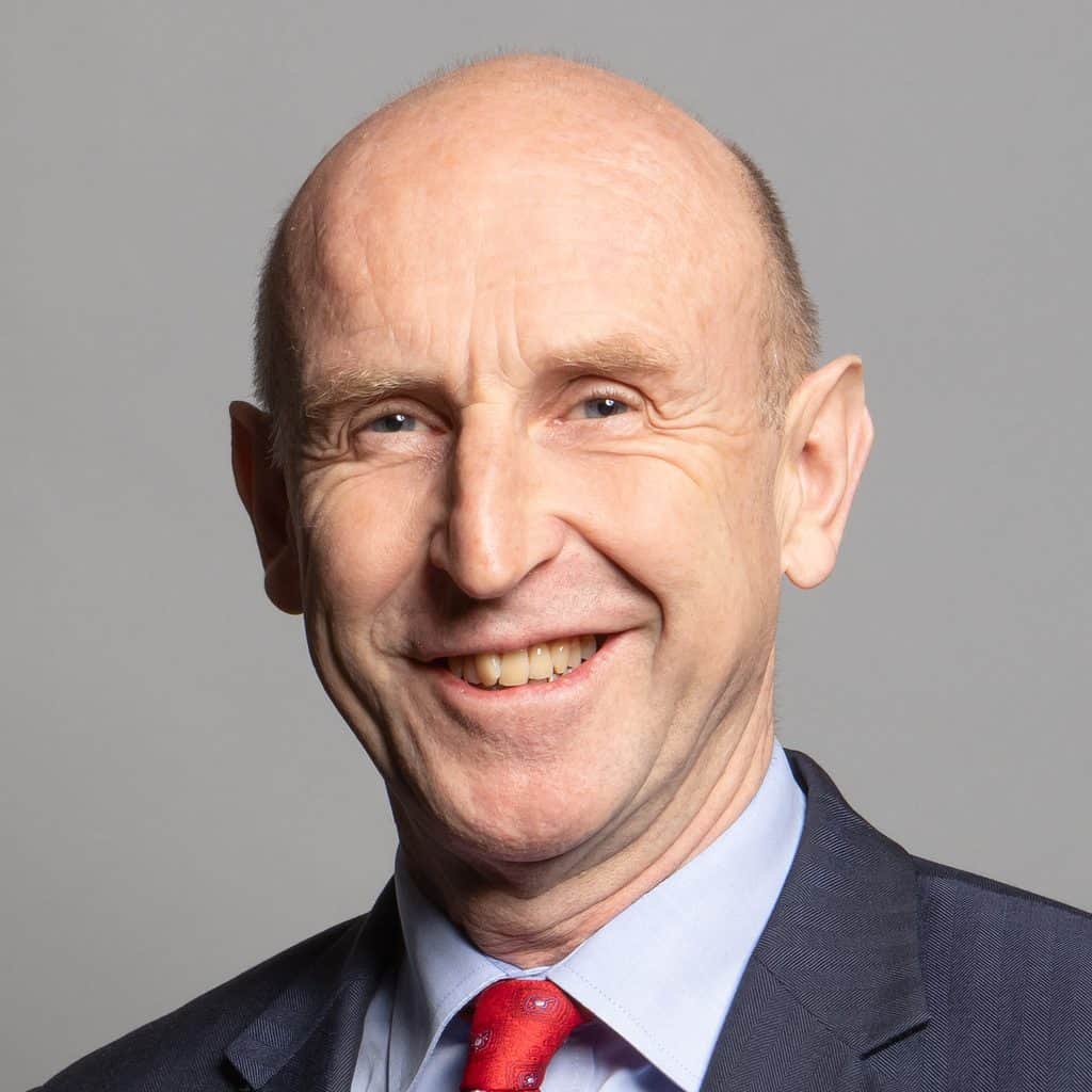Smiling bald man in suit and red tie