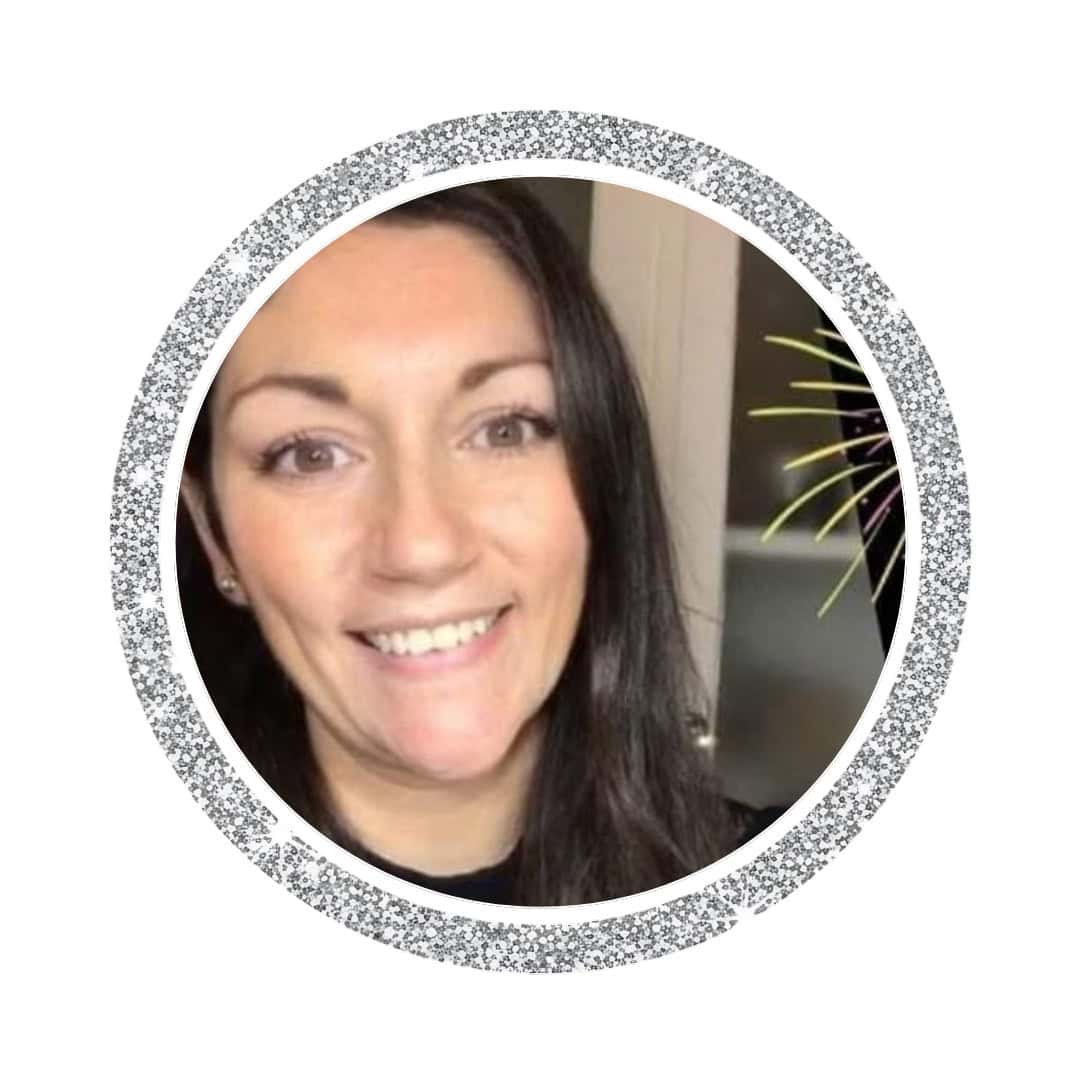 Smiling woman with dark hair in glittery circular frame