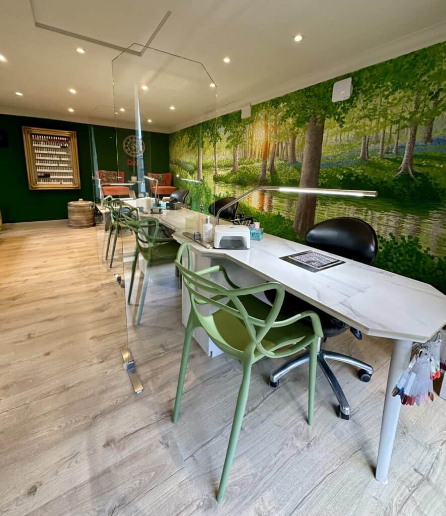 Manicure salon with forest mural and glass partition