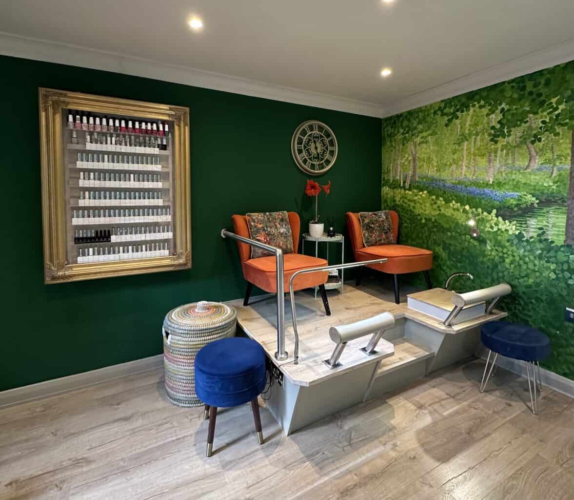 Stylish nail salon with green walls and orange chairs
