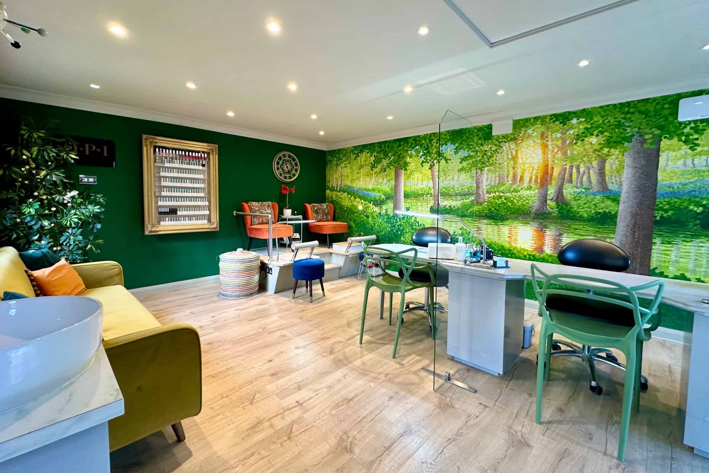 Bright nail salon with forest mural and manicure stations