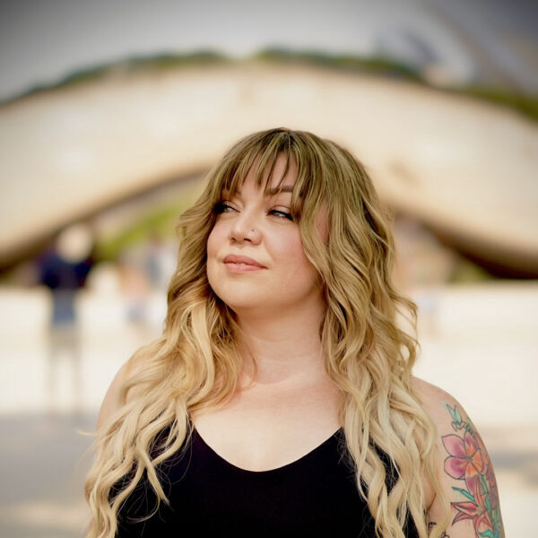 Blonde woman with floral arm tattoo outdoors