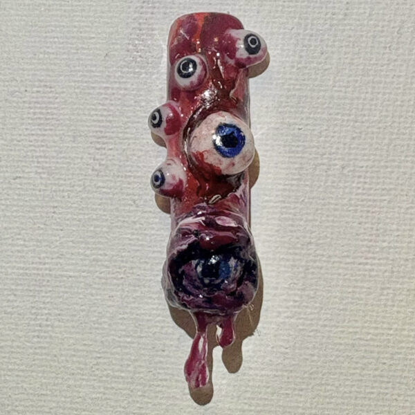 Glossy red ceramic animal figurine with oversized eyes