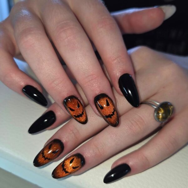 Black and orange jack-o’-lantern Halloween nail art