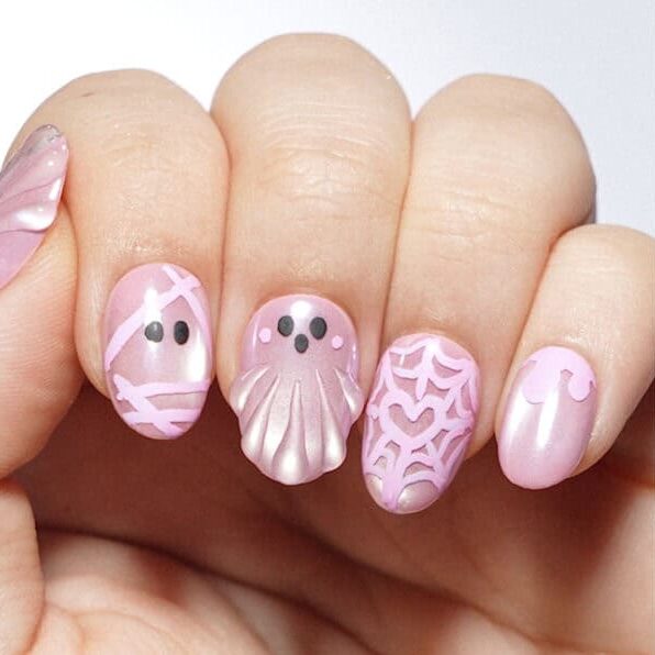 Pink octopus-themed nail art on manicured fingernails
