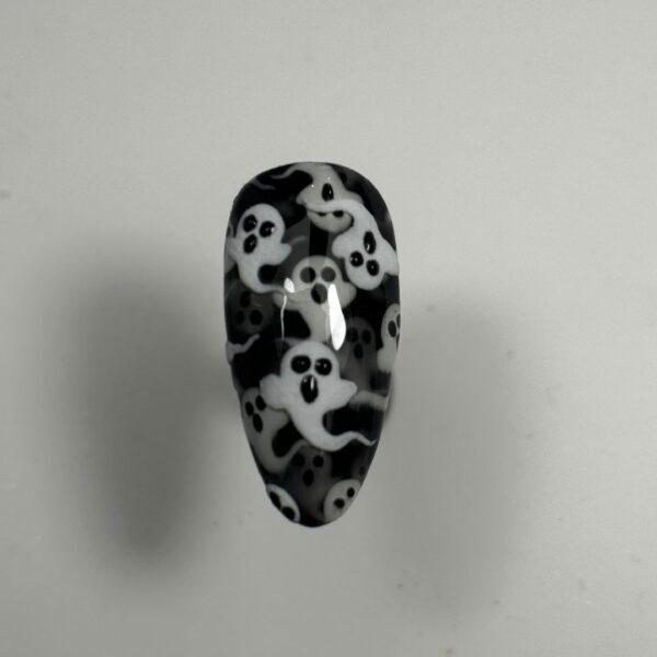 Glossy black false nail with white ghost pattern